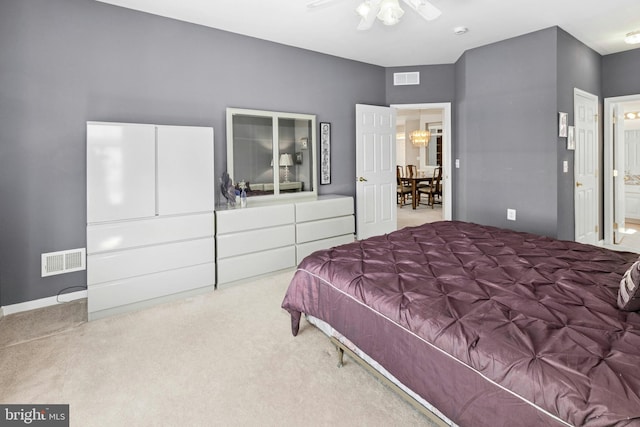 bedroom featuring carpet, ensuite bathroom, and ceiling fan