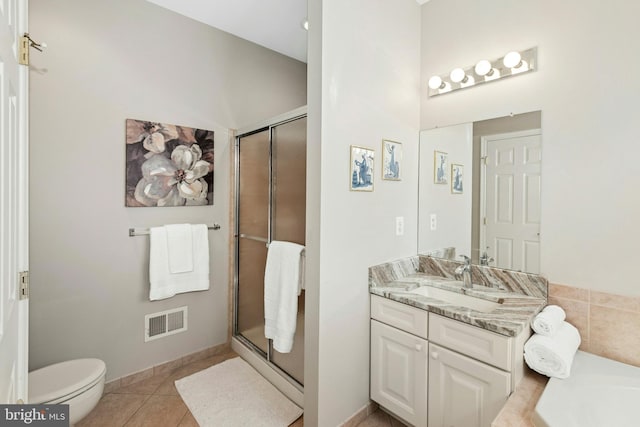 full bathroom featuring a shower stall, vanity, tile patterned floors, toilet, and a high ceiling