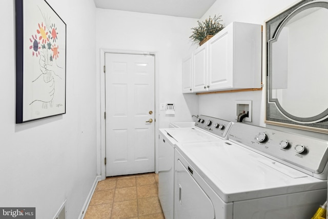 washroom with cabinet space, washing machine and clothes dryer, and baseboards