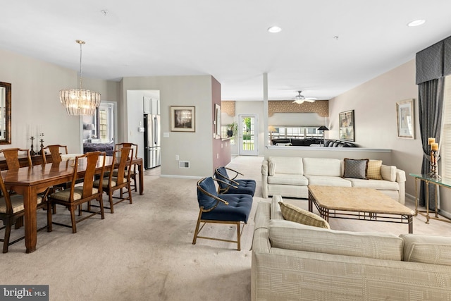 living area featuring light carpet, a chandelier, baseboards, a ceiling fan, and recessed lighting
