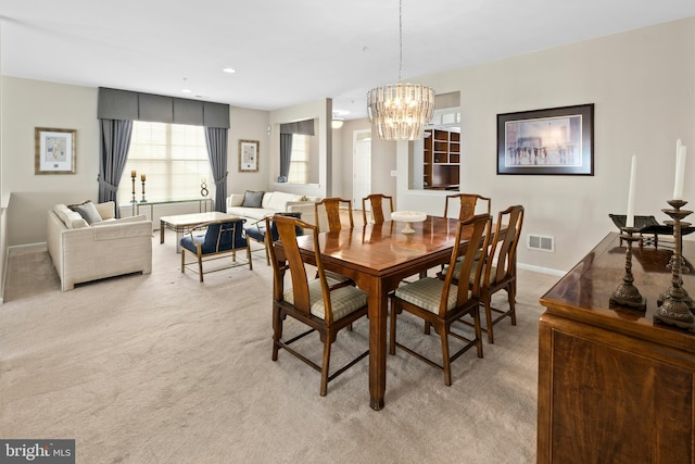 dining room with light colored carpet, a chandelier, baseboards, and recessed lighting