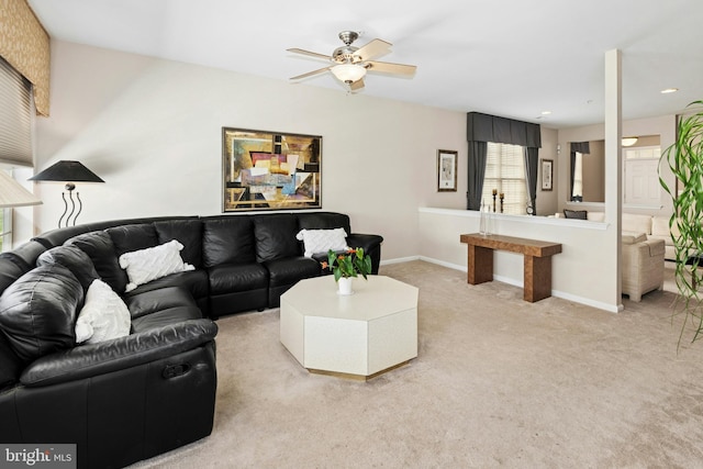 living area featuring light colored carpet, a ceiling fan, baseboards, and recessed lighting