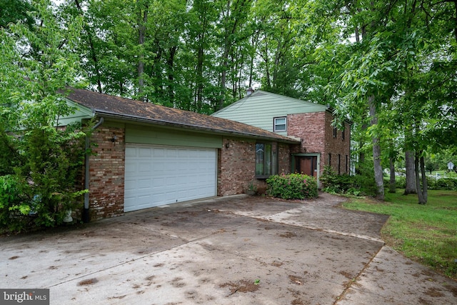 402 Old Courthouse Rd NE, Vienna, VA 22180 - view of front of home with an attached garage, driveway, and brick siding