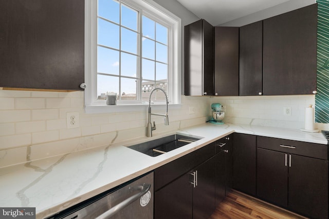 1338 Lowman St, Baltimore, MD 21230 - kitchen featuring a sink, stainless steel dishwasher, decorative backsplash, wood finished floors, and light stone counters