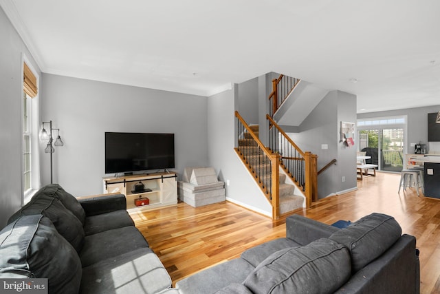 1338 Lowman St, Baltimore, MD 21230 - living room featuring wood finished floors, stairs, ornamental molding, and baseboards
