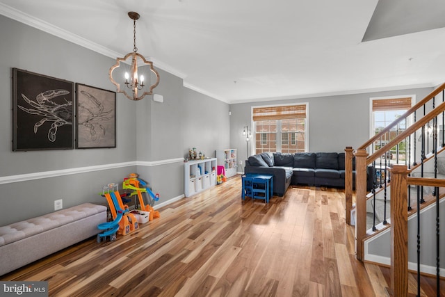 1338 Lowman St, Baltimore, MD 21230 - living area with wood finished floors, a chandelier, stairs, plenty of natural light, and ornamental molding
