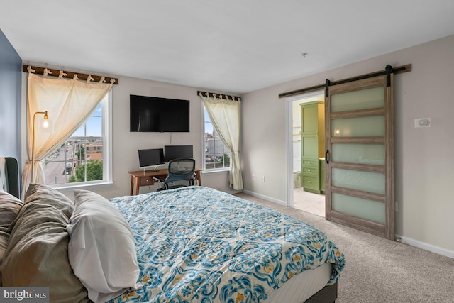1338 Lowman St, Baltimore, MD 21230 - bedroom featuring carpet floors, a barn door, baseboards, and ensuite bath