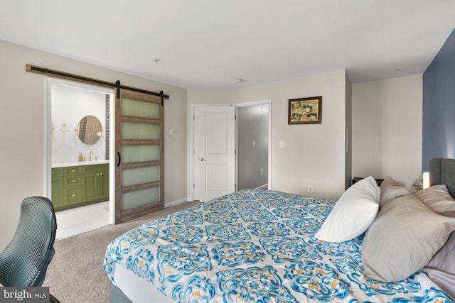 1338 Lowman St, Baltimore, MD 21230 - bedroom with light colored carpet, a sink, a barn door, and connected bathroom