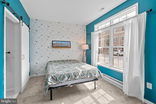 1338 Lowman St, Baltimore, MD 21230 - carpeted bedroom featuring a barn door, baseboard heating, and baseboards