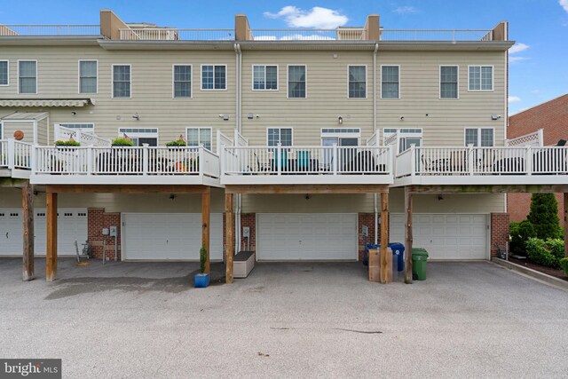 1338 Lowman St, Baltimore, MD 21230 - rear view of property with brick siding and an attached garage