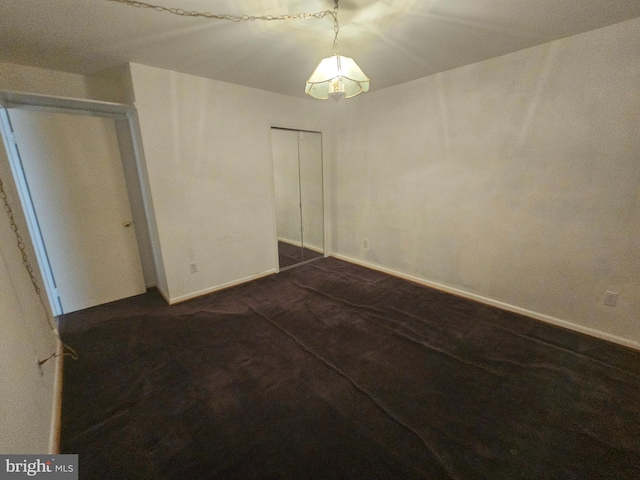 7023 Dolphin Rd, Lanham, MD 20706 - unfurnished bedroom featuring a closet, baseboards, and a chandelier