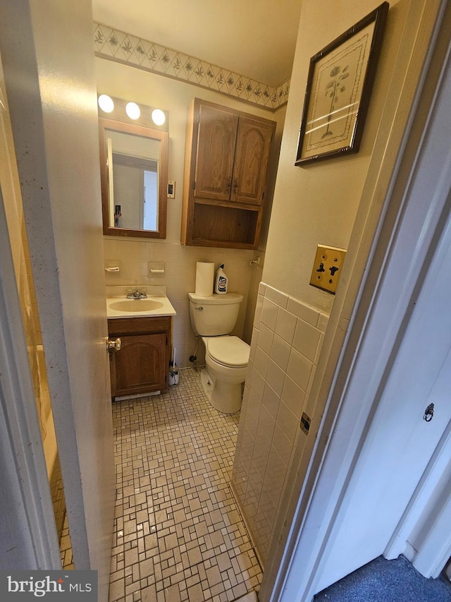7023 Dolphin Rd, Lanham, MD 20706 - half bath with tile walls, toilet, vanity, and tile patterned floors