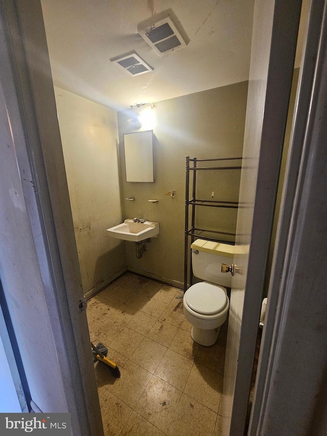 7023 Dolphin Rd, Lanham, MD 20706 - bathroom featuring toilet, tile patterned floors, and a sink