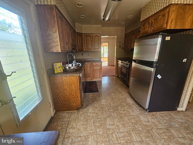 7023 Dolphin Rd, Lanham, MD 20706 - kitchen with freestanding refrigerator, brick patterned floors, a sink, range, and dark countertops