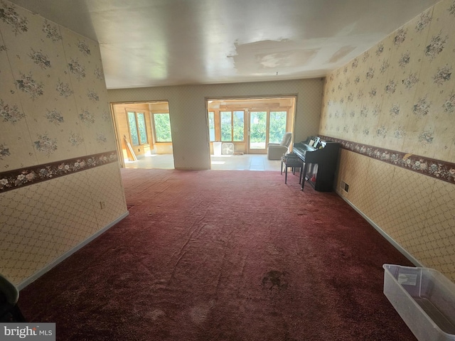 7023 Dolphin Rd, Lanham, MD 20706 - hallway featuring wallpapered walls, healthy amount of natural light, carpet floors, and wainscoting