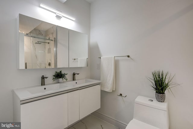 full bath with a marble finish shower, marble look tile flooring, toilet, baseboards, and double vanity