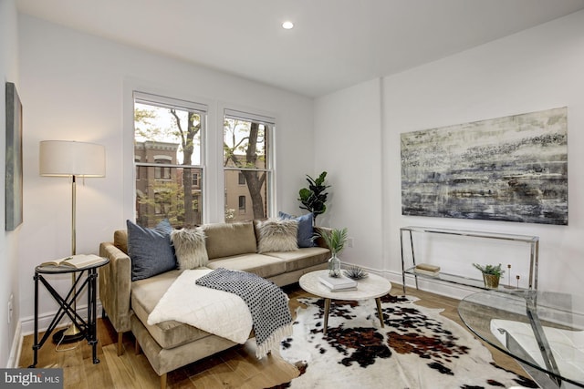 living area with wood finished floors, baseboards, and recessed lighting