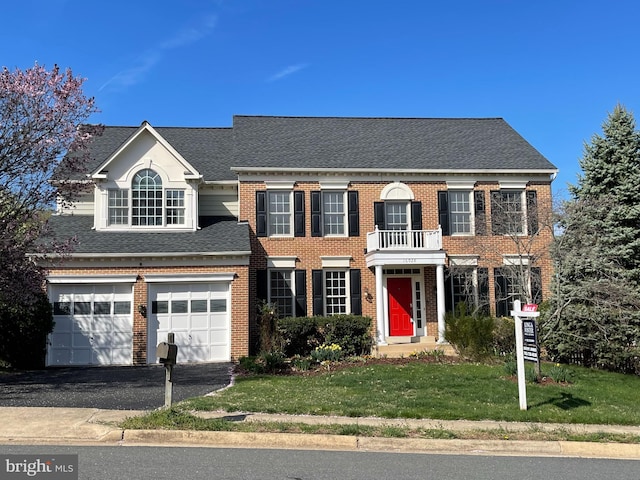 16028 Kings Mountain Rd, Woodbridge, VA 22191 - colonial-style house featuring brick siding, a front yard, driveway, and roof with shingles
