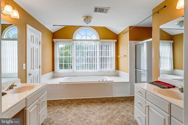 16028 Kings Mountain Rd, Woodbridge, VA 22191 - bathroom featuring vaulted ceiling, a shower stall, a bath, two vanities, and tile patterned floors