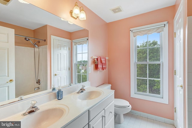 16028 Kings Mountain Rd, Woodbridge, VA 22191 - bathroom with toilet, double vanity, baseboards, and tile patterned floors