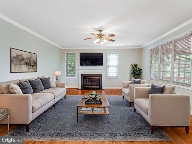 16028 Kings Mountain Rd, Woodbridge, VA 22191 - living area with crown molding, wood finished floors, ceiling fan, a fireplace with flush hearth, and baseboards