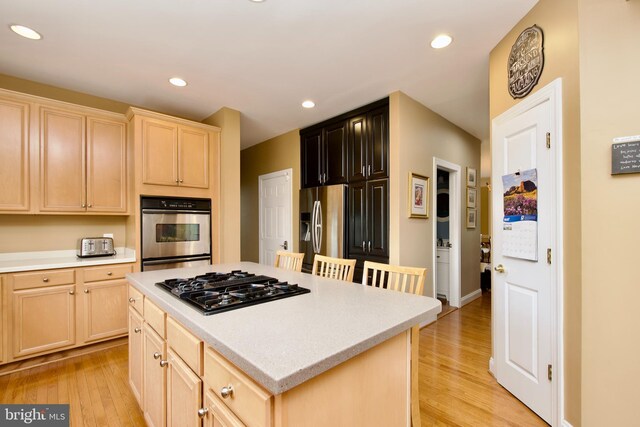 8931 Kiger St, Lorton, VA 22079 - kitchen featuring stainless steel appliances, light brown cabinets, light countertops, light wood-type flooring, and recessed lighting