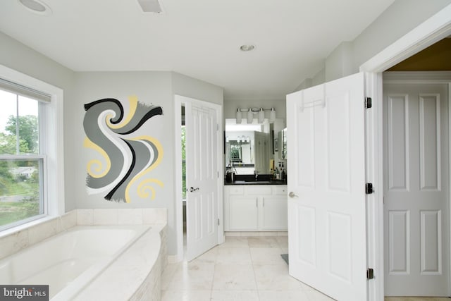 8931 Kiger St, Lorton, VA 22079 - bathroom with a bath, vanity, recessed lighting, and marble look tile flooring