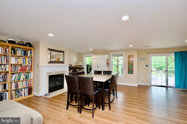 8931 Kiger St, Lorton, VA 22079 - dining room with a fireplace with flush hearth, light wood-style flooring, baseboards, and recessed lighting