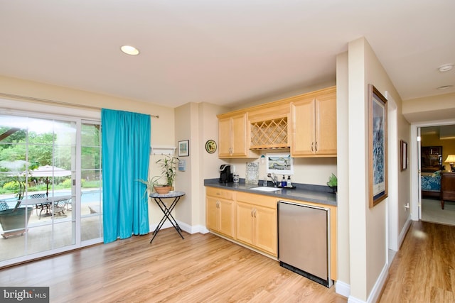 8931 Kiger St, Lorton, VA 22079 - kitchen with light brown cabinetry, dark countertops, a sink, light wood-style flooring, and recessed lighting