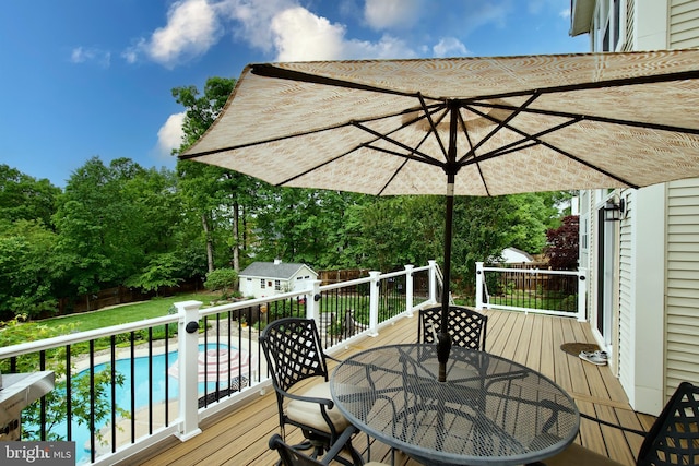 8931 Kiger St, Lorton, VA 22079 - deck featuring outdoor dining space, an outbuilding, and view of wooded area