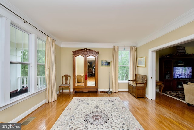 8931 Kiger St, Lorton, VA 22079 - living area featuring crown molding, light wood-type flooring, and baseboards