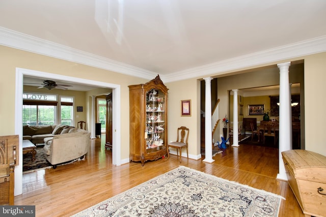 8931 Kiger St, Lorton, VA 22079 - living room with decorative columns, ornamental molding, light wood-style flooring, baseboards, and stairs