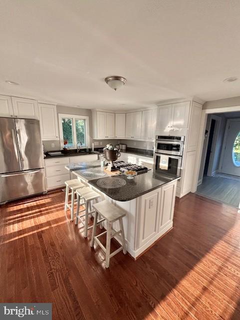 20456 Quarter Landing Ln, Nanticoke, MD 21840 - kitchen featuring appliances with stainless steel finishes, dark wood-type flooring, and white cabinetry