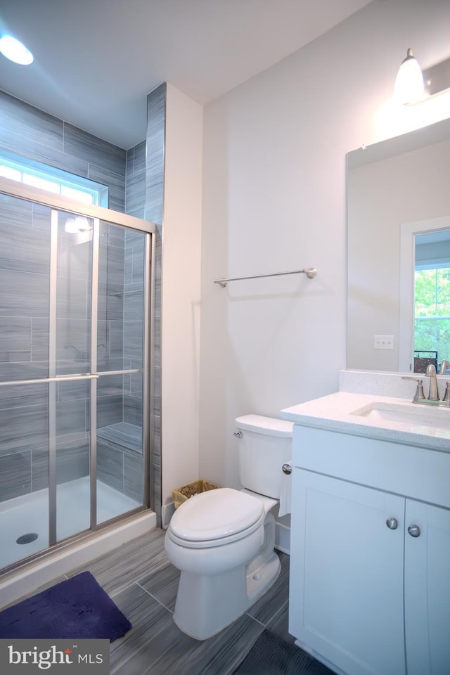 23883 Ebony Eyes Ct, Aldie, VA 20105 - bathroom featuring a shower stall, toilet, and vanity