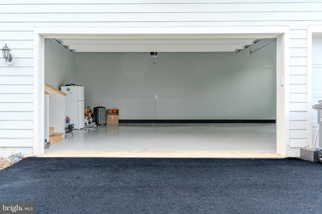 23883 Ebony Eyes Ct, Aldie, VA 20105 - garage featuring freestanding refrigerator
