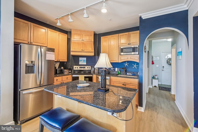 105 56th Unit 210P1, Ocean City, MD 21842 - kitchen with stainless steel appliances, a sink, arched walkways, light wood-type flooring, and baseboards