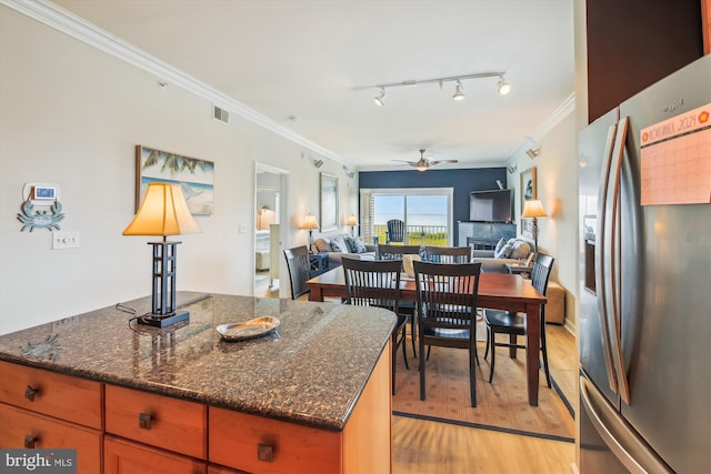 105 56th Unit 210P1, Ocean City, MD 21842 - kitchen featuring stainless steel fridge, ceiling fan, crown molding, light wood-style flooring, and a fireplace