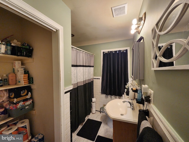 703 Beaverbrook Rd, Baltimore, MD 21212 - bathroom with wainscoting, a sink, and a shower with shower curtain