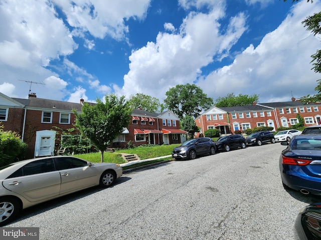 view of car parking featuring a residential view