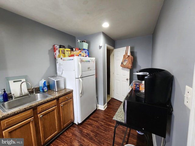 703 Beaverbrook Rd, Baltimore, MD 21212 - kitchen with a sink, freestanding refrigerator, brown cabinetry, dark wood finished floors, and baseboards