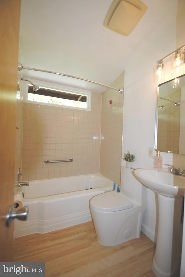 7807 Sycamore Dr, Falls Church, VA 22042 - full bath with wood finished floors, toilet, and washtub / shower combination