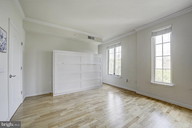 1441 Rhode Island Ave NW Unit 817, Washington, DC 20005 - unfurnished bedroom featuring ornamental molding, light wood-style flooring, multiple windows, and baseboards
