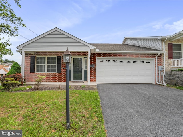 view of front facade featuring driveway, brick siding, a garage, and a front lawn