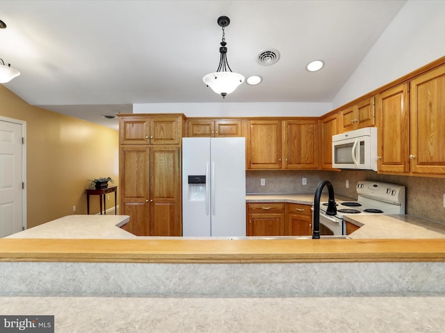 kitchen featuring white appliances, light countertops, vaulted ceiling, brown cabinets, and backsplash