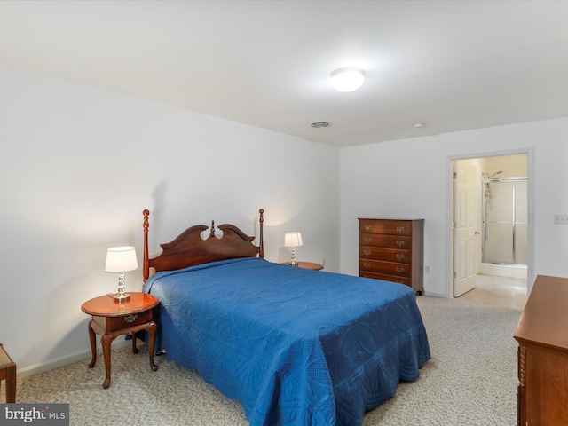 carpeted bedroom with baseboards and connected bathroom