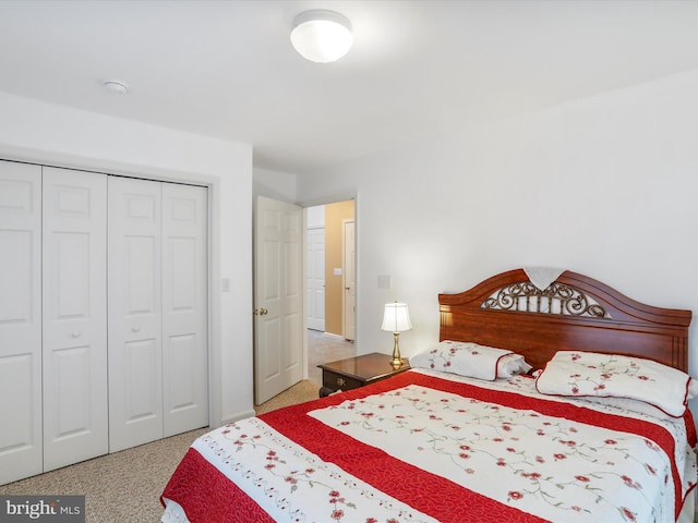 bedroom featuring a closet and light carpet