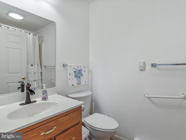 full bathroom with toilet and vanity