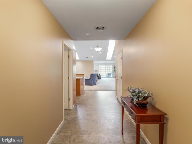 corridor featuring baseboards