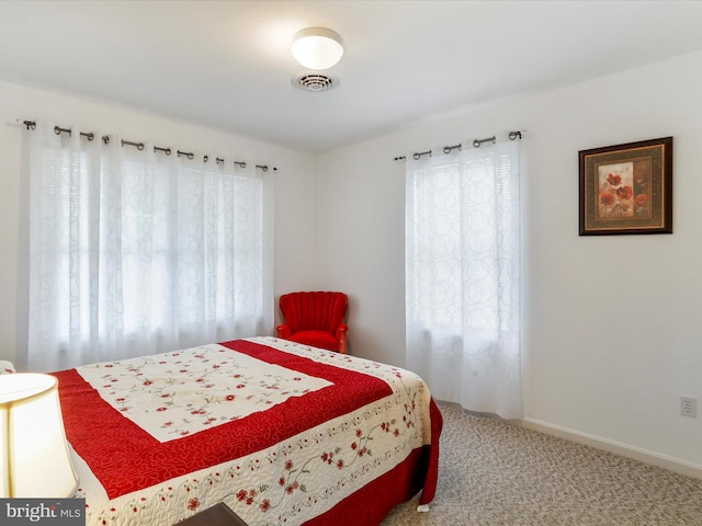 bedroom with carpet floors and baseboards