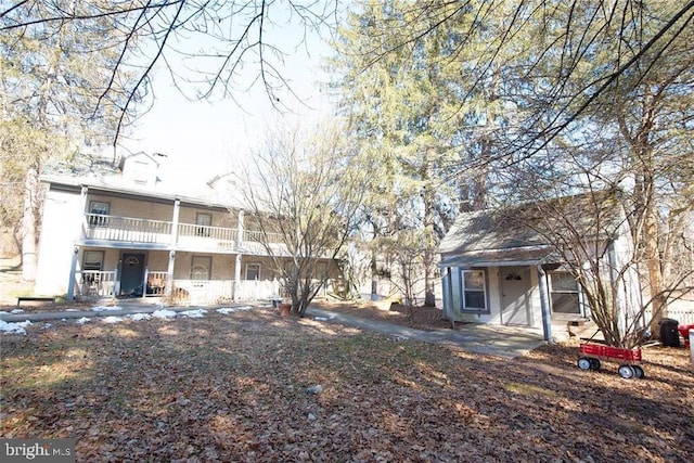 1025 Reihman Rd, Green Lane, PA 18054 - rear view of property with a porch, a balcony, stucco siding, and a chimney